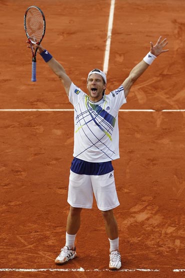 Jurgen Melzer celebrates after beating Novak Djokovic