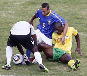 Brazil's Luis Fabiano fights for the ball against Zimbabwe's Nengomasha during their friendly match