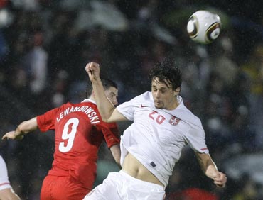 Serbia's Subotic fights for the ball with Poland's Lewandowski during a friendly match in Kufstein