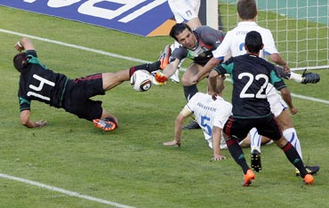 Mexico's Hernandez challenges Italy's goalie Buffon during their international friendly match