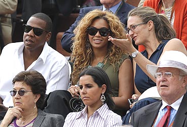 Former French Open champion Mary Pierce (right) chats with American musicians Beyonce (centre) and Jay-Z during the French Open men's final