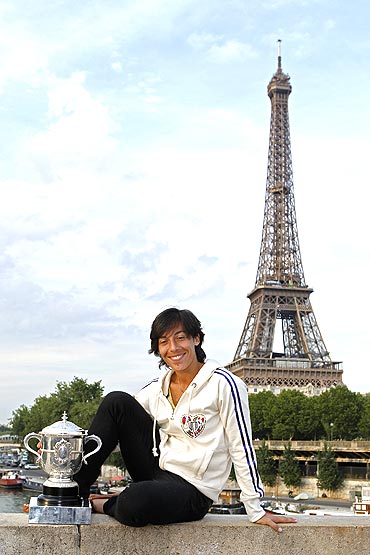 Francesca Schiavone of Italy poses with her trophy near the Eiffel Tower