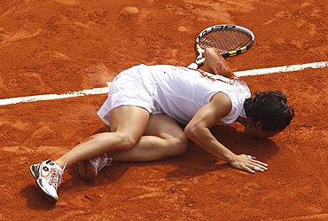 Francesca Schiavone of Italy kisses the court after winning the French Open title