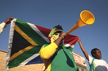 A supporter of South Africa blows his vuvuzela