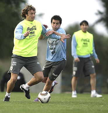 Uruguay's Diego Lugano (left) and Nicolas Lodeiro vie for possession during a practice match
