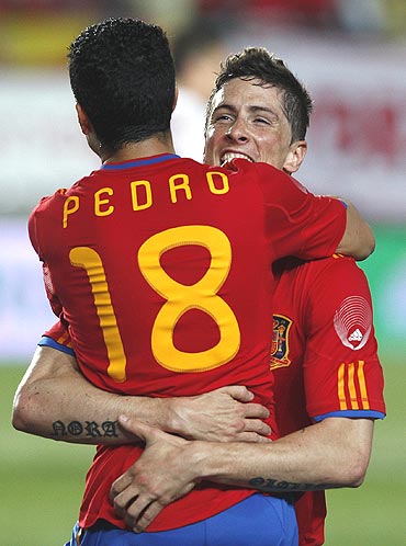 Spain's Fernando Torres (right) celebrates with team-mate Pedro Rodriguez after netting the fifth goal