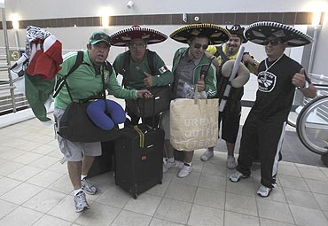 Mexican fans shout slogans at the new Sandton train station in Johannesburg