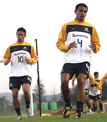 Australia's Harry Kewell (left) and Tim Cahill jog during a practice session