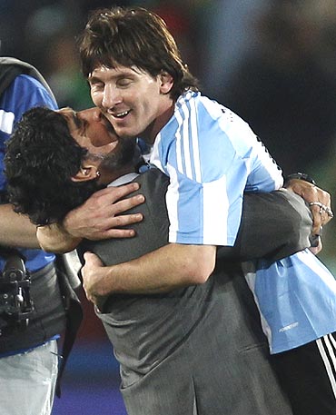 Argentina's coach Diego Maradona (left) hugs Lionel Messi after the match