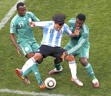 Argentina's Carlos Tevez (centre) vies for possession with Nigeria's Chinedu Obasi and Yakubu Aiyegbeni