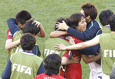 South Korean players celebrate after winning the match against Greece