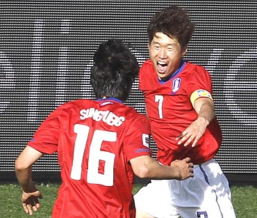 Parki Ji-sung celebrates after scoring with team-mates