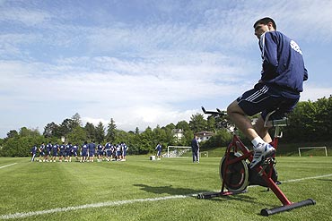 Paraguay's Oscar Cardozo (left) cycles as his team-mates train during a practice session
