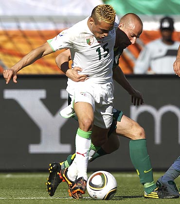 Algeria's Karim Ziani (left) fights for the ball against Slovenia's Miso Brecko