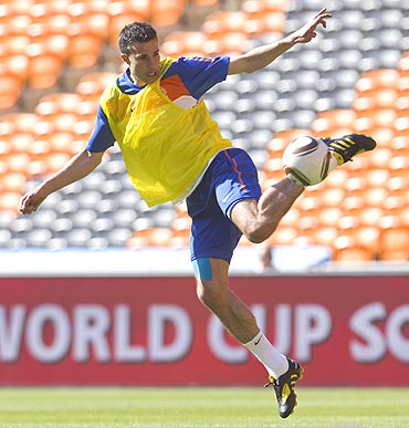 Robin van Persie of the Netherlands kicks the ball during a training session