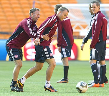 Denmark's Dennis Rommedahl (left) and team-mate Lars Jacobsen share a light moment during a training session