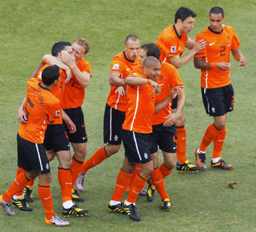 Netherlands' players celebrate after an own goal by Denmark