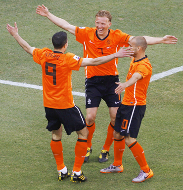 Netherlands' Dirk Kuyt, Wesley Sneijder and Robin van Persie celebrate against Denmark