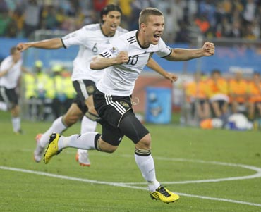 Lukas Podolski celebrates after scoring