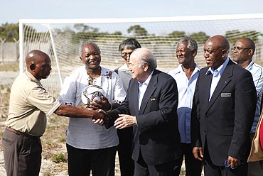 FIFA president Sepp Blatter (centre) chats with members of the Makana Football Association in Robben Island