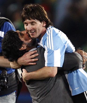 Argentina coach Diego Maradona hugs Lionel Messi