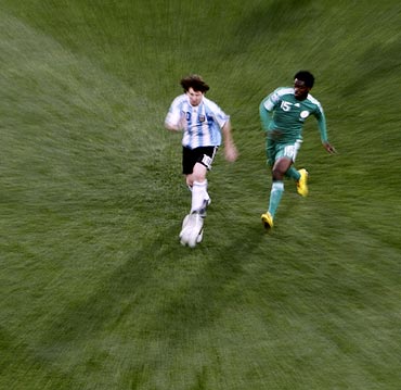 Lionel Messi gets the ball past Nigeria's Haruna Lukman