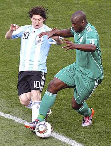 Argentina's Lionel Messi and Nigeria's Danny Shittu vie for possession