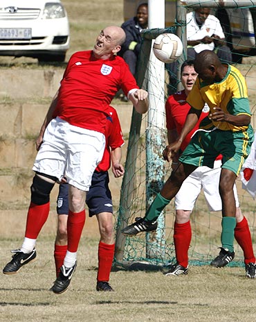 England fan Ian Hart (left) and inmate Joseph Mawelewele are involved in an aerial duel