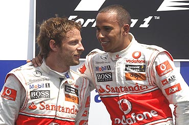 McLaren's Lewis Hamilton (right) celebrates with team-mate Jenson Button on the podium after winning the Canadian GP
