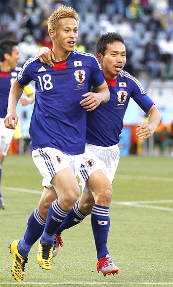 Keisuke Honda (left) celebrates with a team-mate after scoring against Cameroon