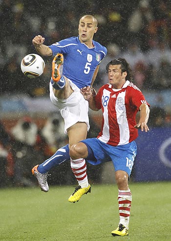 Italy's Fabio Cannavaro and Paraguay's Nelson Haedo Valdez (right) vie for possession