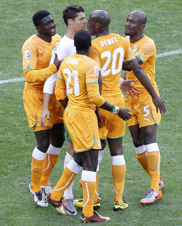 Portugal's Cristiano Ronaldo argues with Ivory Coast's Guy Demel while teammate Emmanuel Eboue watches