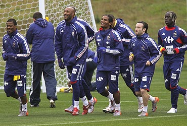 French players warm up during a training session