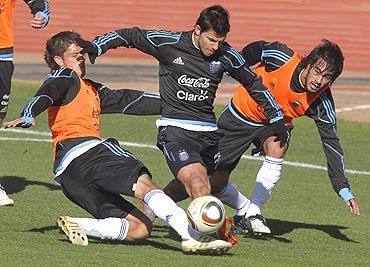 Argentina's Sergio Aguero (centre) battles for the ball with team-mates during a practice match