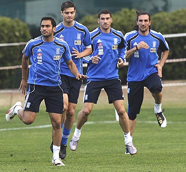Greeck players stretch during a training session