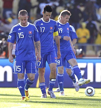 Slovakian players Miroslav Stoch (left), Marek Hamsik (centre) and Juraj Kucka walk off the pitch after their match against New Zealand