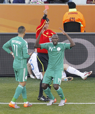 Nigeria's Sani Kaita (R) reacts after referee Oscar Ruiz of Colombia shows him a red card