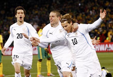 Diego Forlan (right) celebrates with team-mates after scoring
