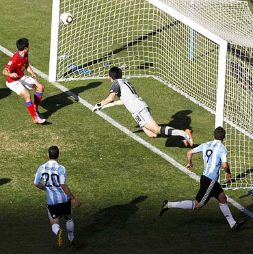 Gonzalo Higuain heads in the ball to complete his hat-trick