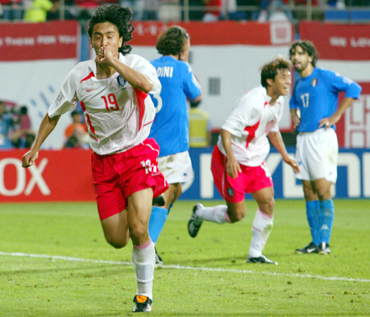 South Korea's Ahn Jung-hwan (left) celebrates his golden goal with teammate Hwang Sun-hong (second right) as Italy's Paolo Maldini (second left) and Damiano Tommasi stand in disbelief