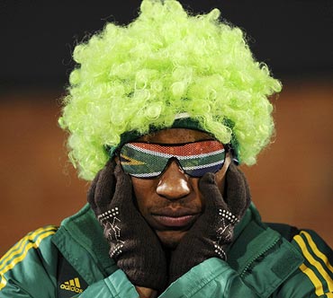 A South African fan reacts after his team's loss to Uruguay