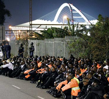 Security personnel are held by police in Durban