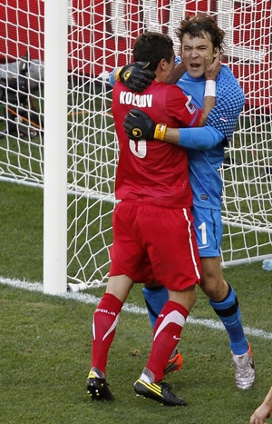 Serbian keeper Stojkovic is congratulated by a teammate after saving a penalty