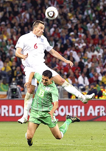 Algeria's Karim Matmour and England's John Terry (left) vie for possession