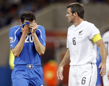 Italy's Giampaolo Pazzini reacts near New Zealand's Ryan Nelsen