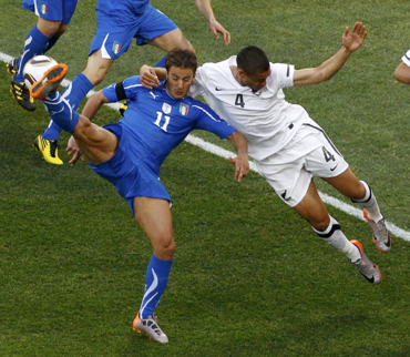 Italy's Gilardino fights for the ball with New Zealand's Reid during their 2010 World Cup Group F soccer match