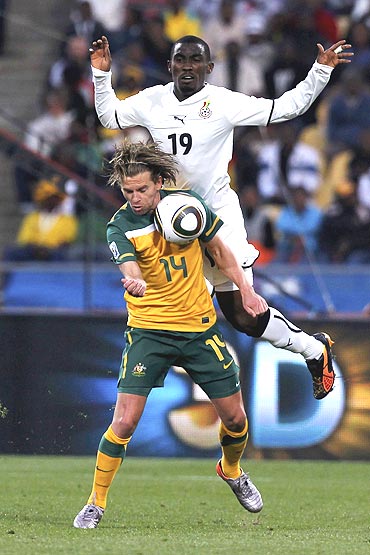 Australia's Brett Holman and Ghana's Lee Addy vie for possession