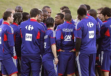 French players listen to their captain Patrice Evra (centre) before deciding not to take part in a training session