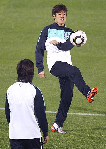 South Korea's Park Ji-sung (right) trains with a teammate during a practice session