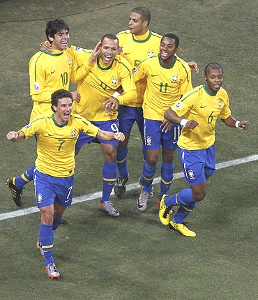 Brazil's Elano (7) celebrates with teammates after scoring
